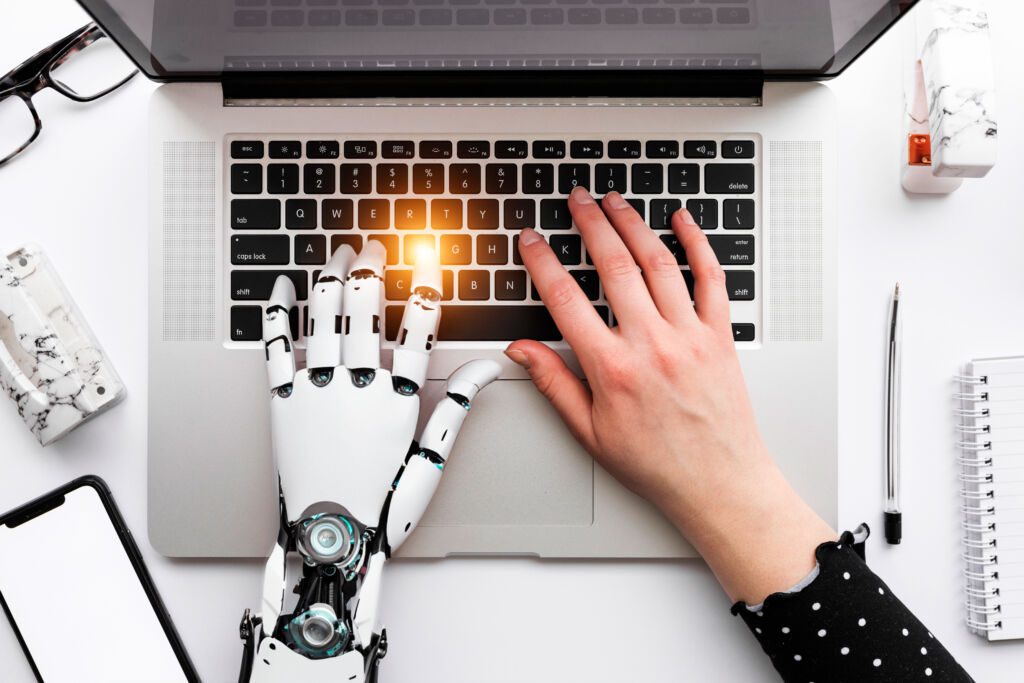 Artificial Intelligence Hand and Human Hand Typing on a Keyboard