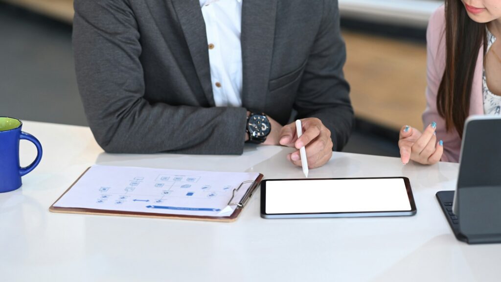 Business people working with digital tablet and planning marketing plan to improve.